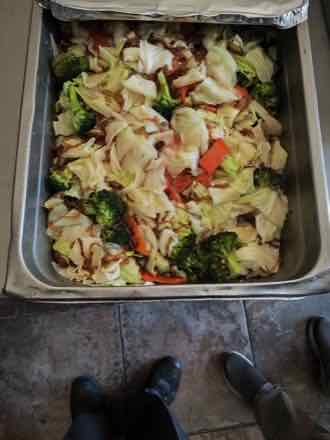 Cabbage with broccoli and pepper Catering pan of stir-fried cabbage leaves with broccoli florets, red bell pepper strips and shredded onion