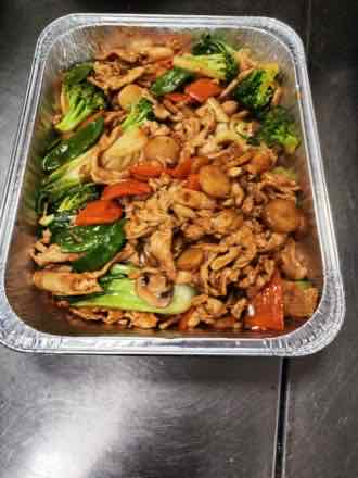 Chicken with mixed vegetables Catering tray of sliced chicken stir-fried with broccoli, snow peas, bok choy, mushrooms, carrots and bamboo shoots in brown sauce