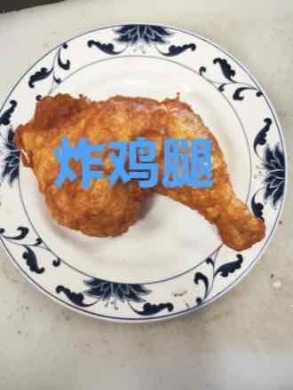 Crispy fried chicken leg Golden deep-fried bone-in chicken leg quarter served on a blue-and-white porcelain plate