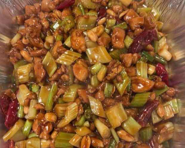 Full-size catering tray of kung pao chicken with celery, peanuts and dried chili